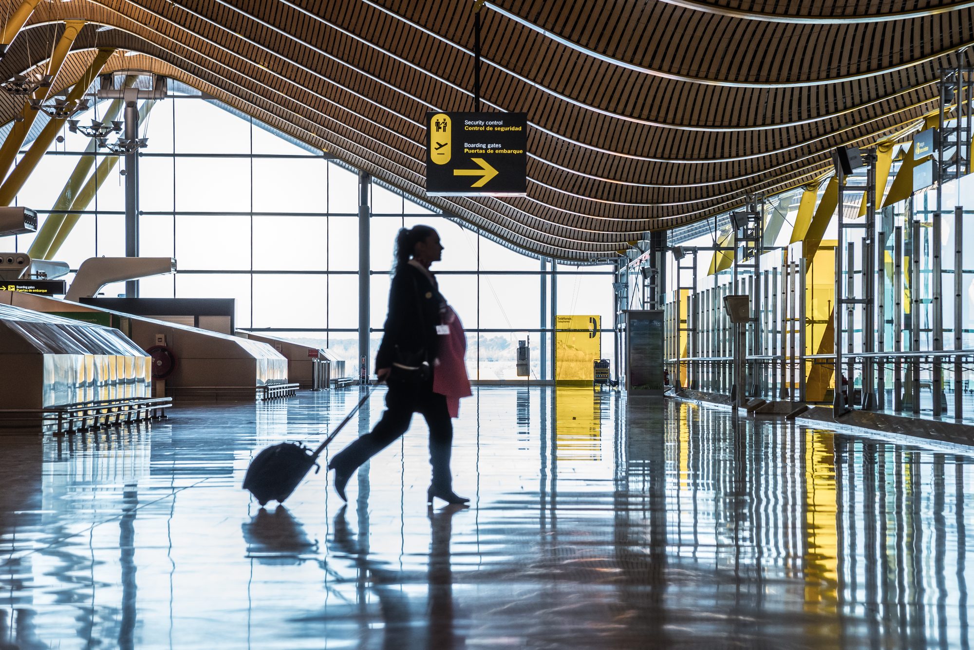 Traveller walking through a modern airport concourse