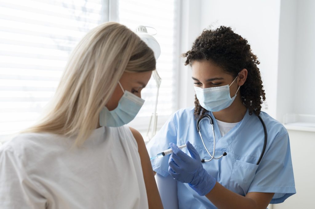 Travel clinic nurse preparing a vaccination