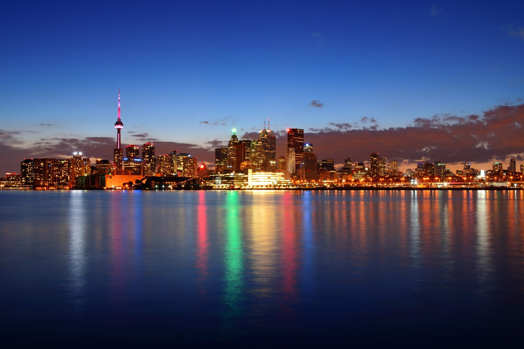 Toronto skyline at dusk with the CN Tower reflected in the lake