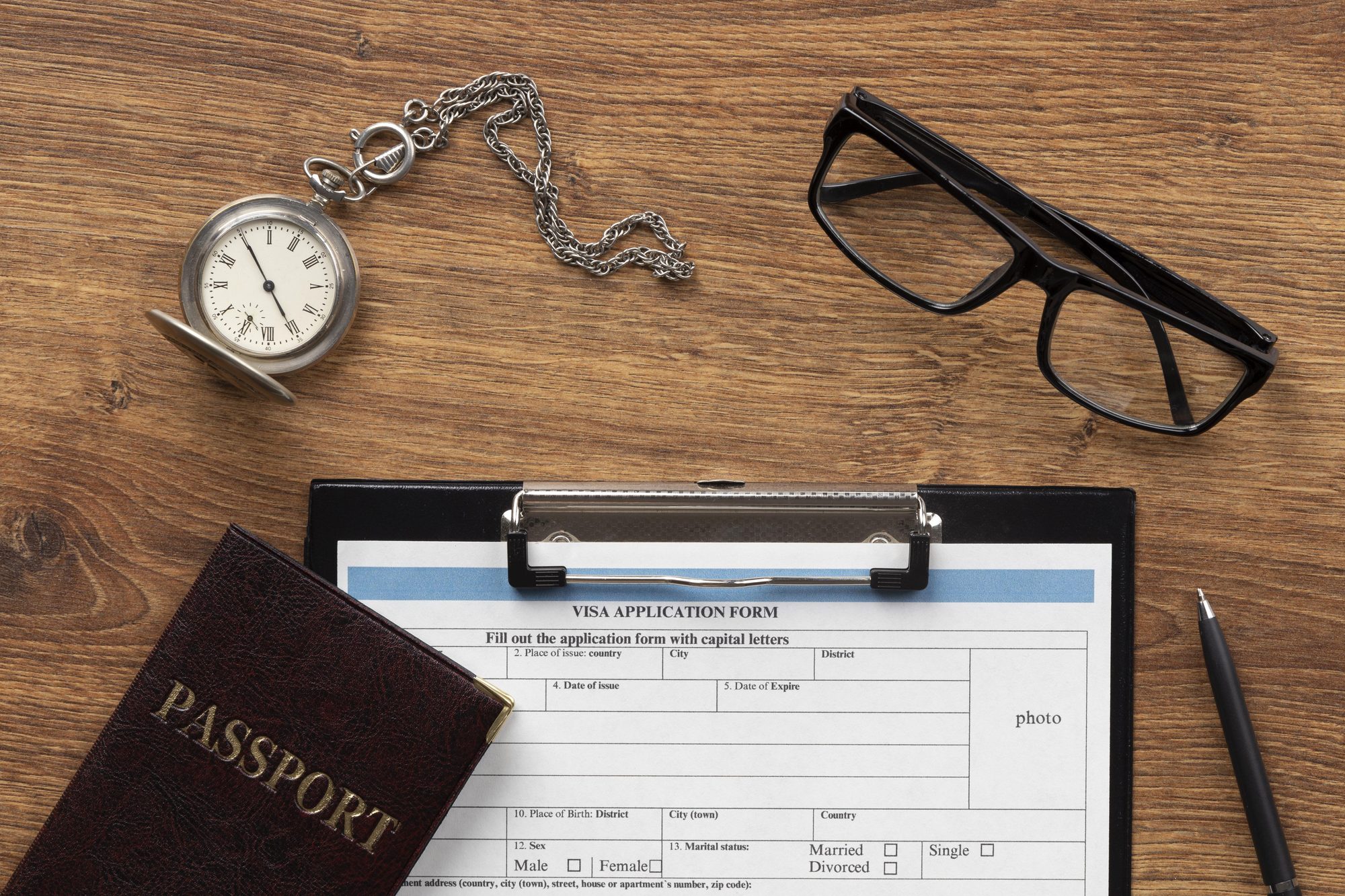 Schengen visa application documents and passport prepared on a desk