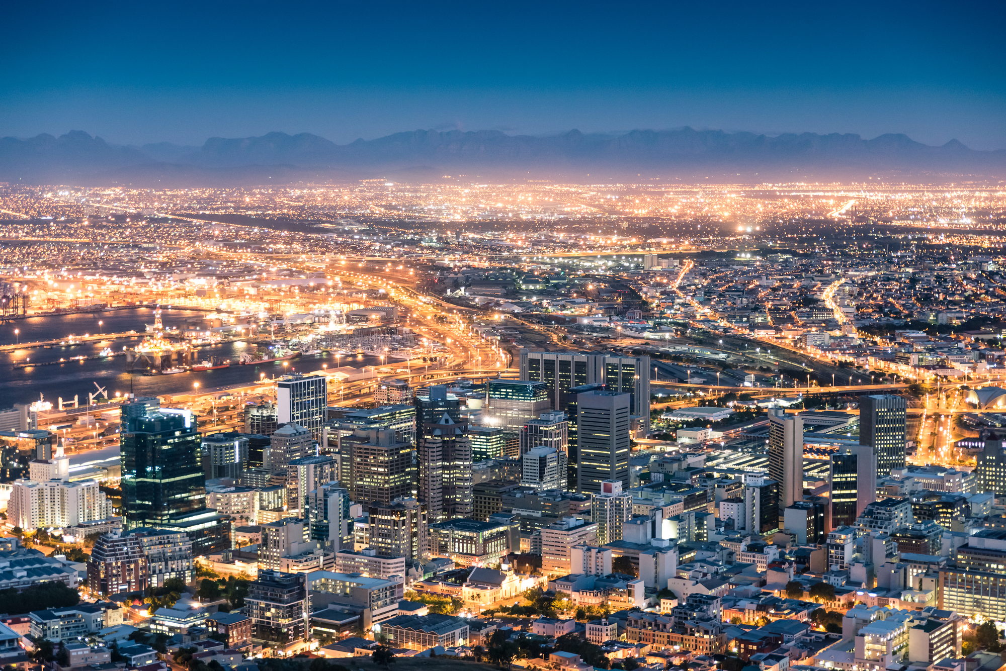 Cape Town city bowl and harbour lit up at dusk