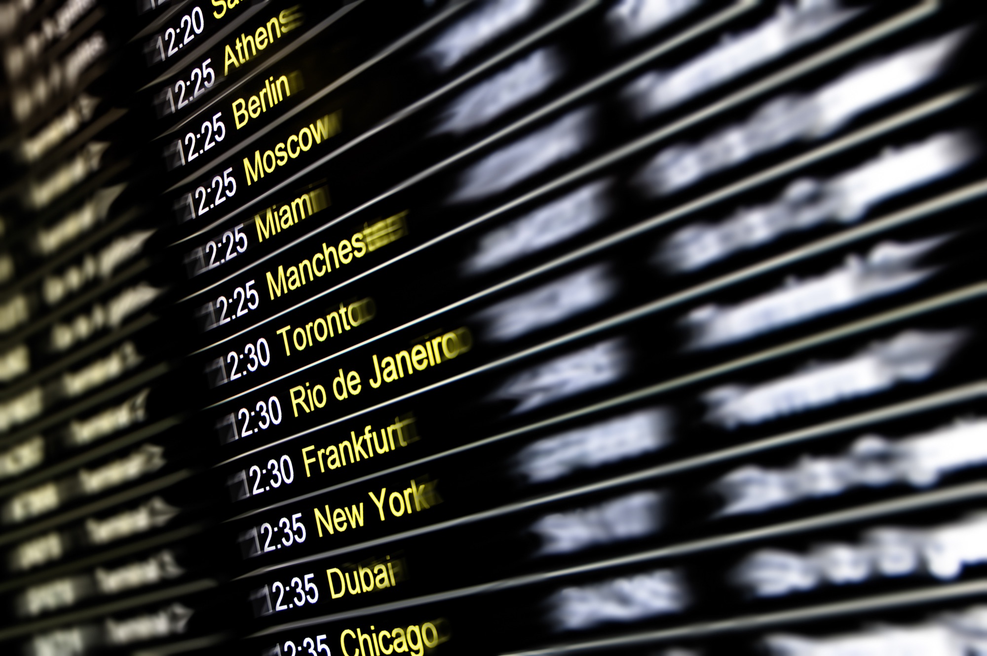 An airport departures board listing a Dubai flight