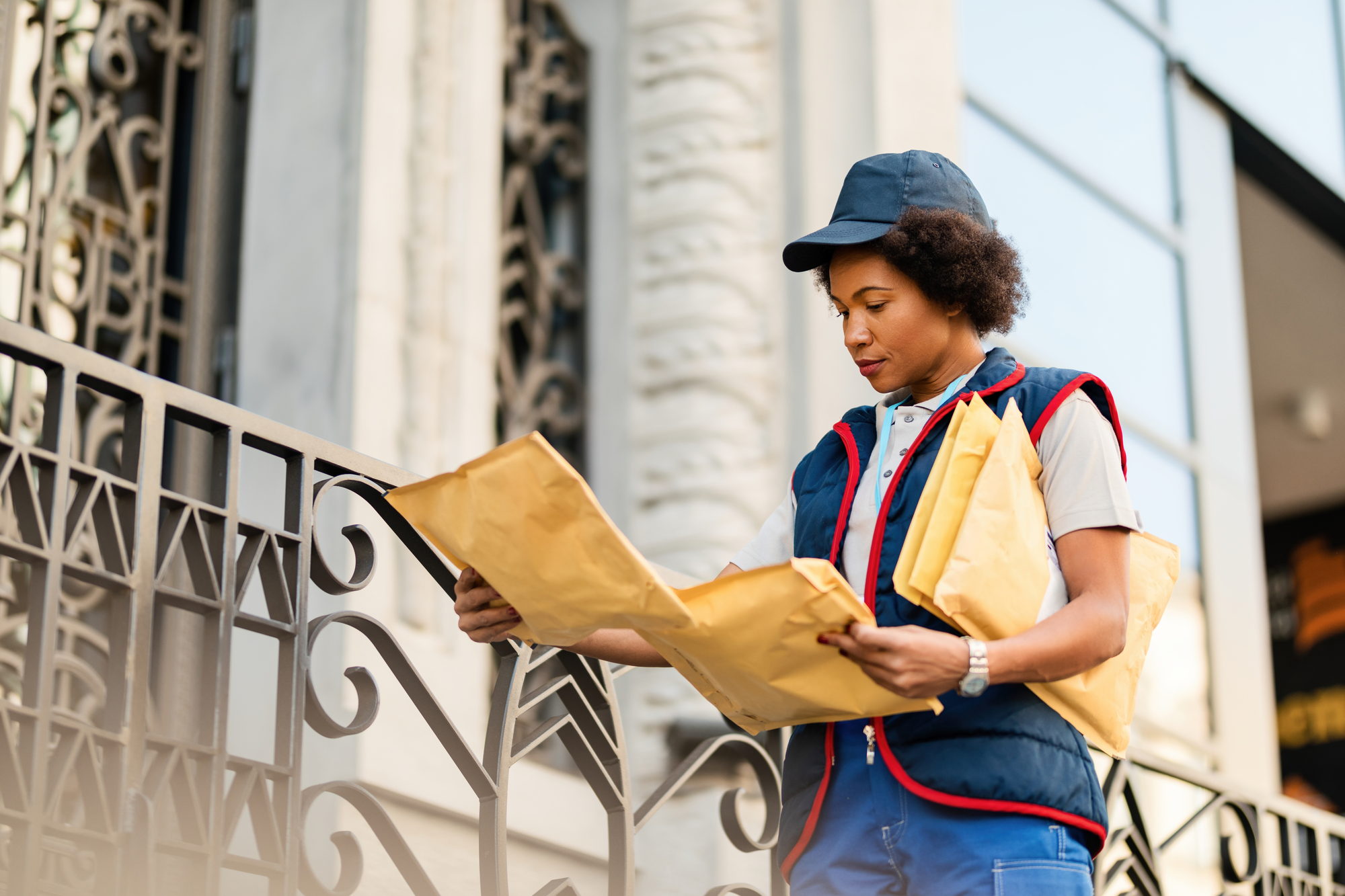 A courier checking envelopes before delivery