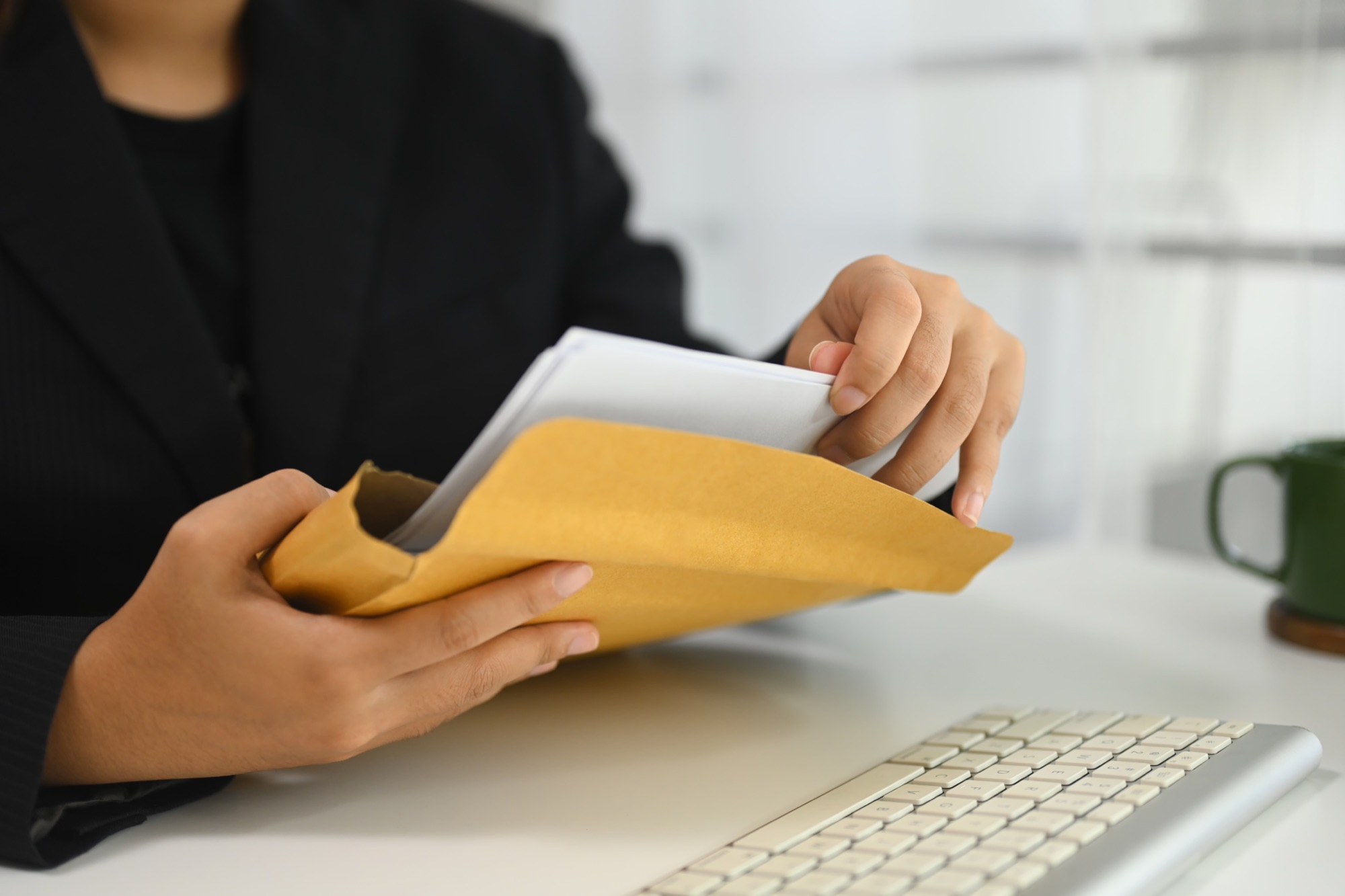 Supporting documents being checked and placed in an envelope