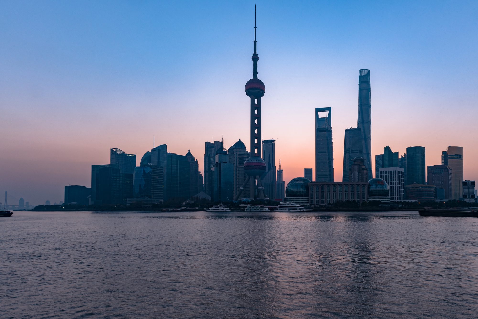 The Pudong skyline in Shanghai across the Huangpu River at twilight