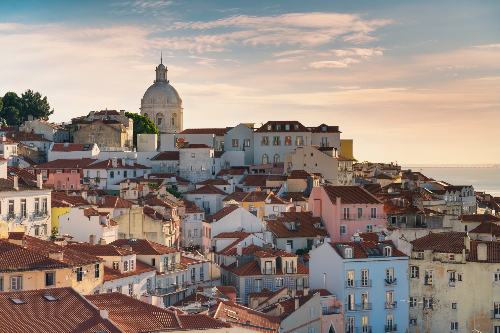 The rooftops of Alfama in Lisbon and the dome of the National Pantheon in morning light